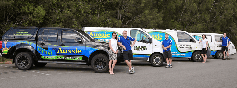 staff at aussie pest control sunshine coast leaning on their exterminator work vans